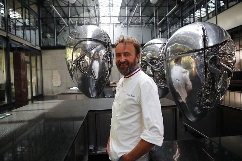 Le chocolatier Patrick Roger présente à côté de ses sculptures inspirées du pape François dans son usine-atelier de Sceaux, Paris.