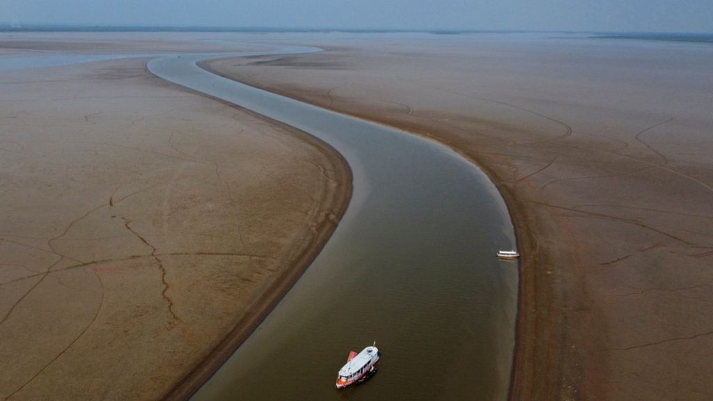 A ferry boat travels through a section of the Amazon River affected by a severe drought, near Manacapuru.