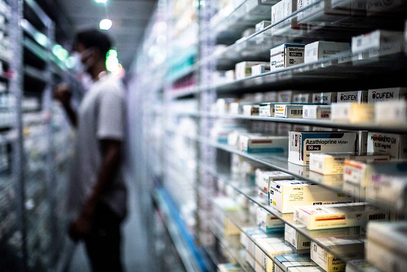 Un pharmacien stocke des médicaments à Paris.