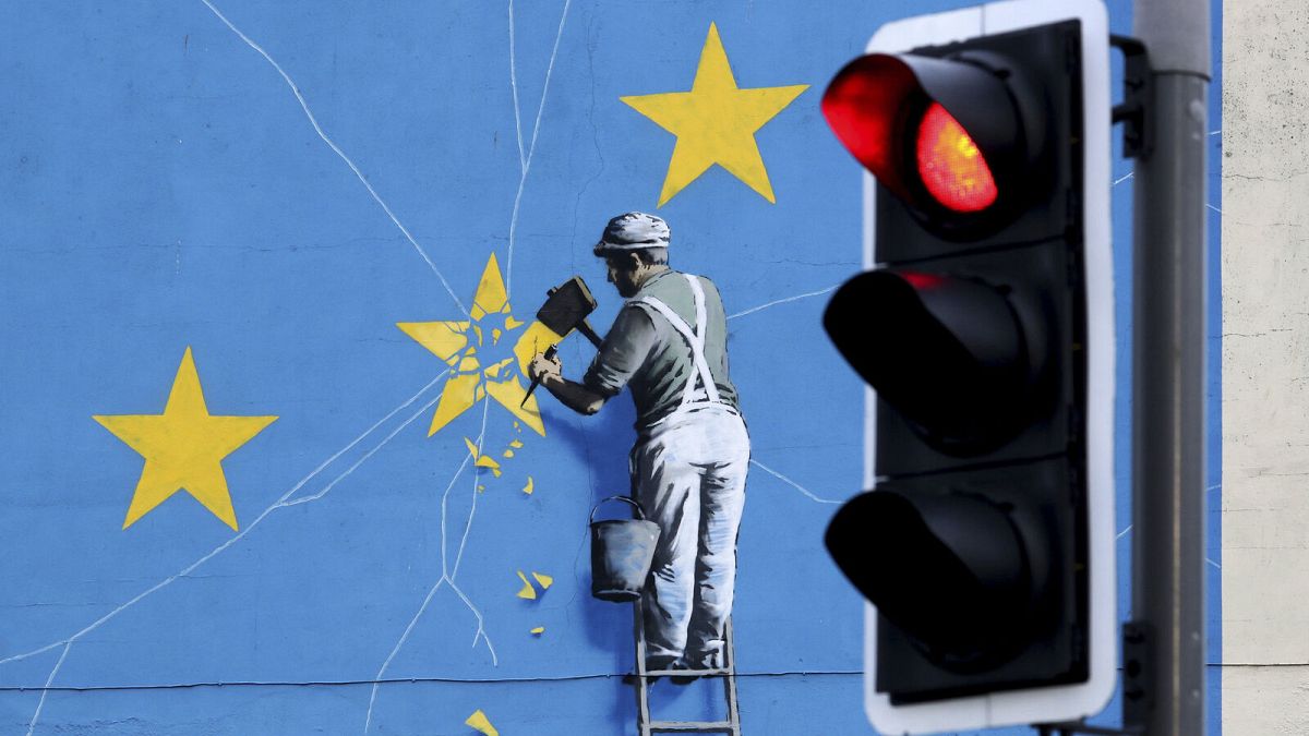 A view of the Banksy Brexit mural of a man chipping away at the EU flag in Dover, England, Tuesday, 11 December 2018.