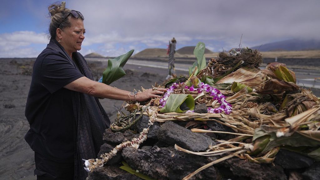 Kealoha Pisciotta, a cultural practitioner and longtime activist, lays offerings before praying at an