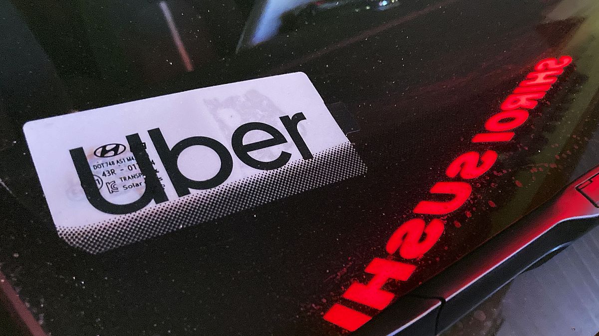 An Uber sign is displayed inside a car in Glenview, Ill., on Dec. 17, 2022.