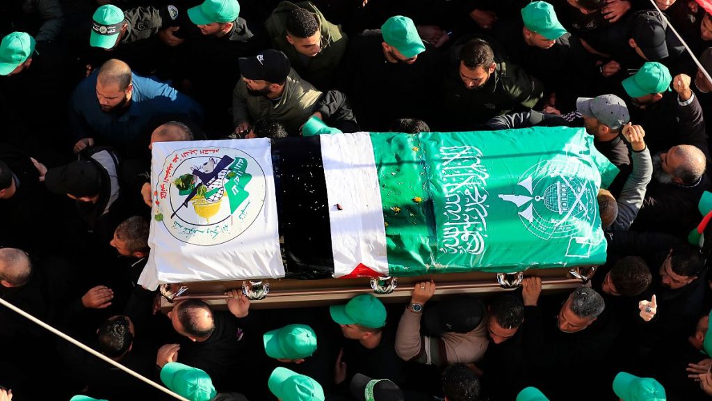 Fighters carry the coffin of one of seven Hamas members, including the top Hamas political leader Saleh Arouri, who were killed by an apparent Israeli strike.