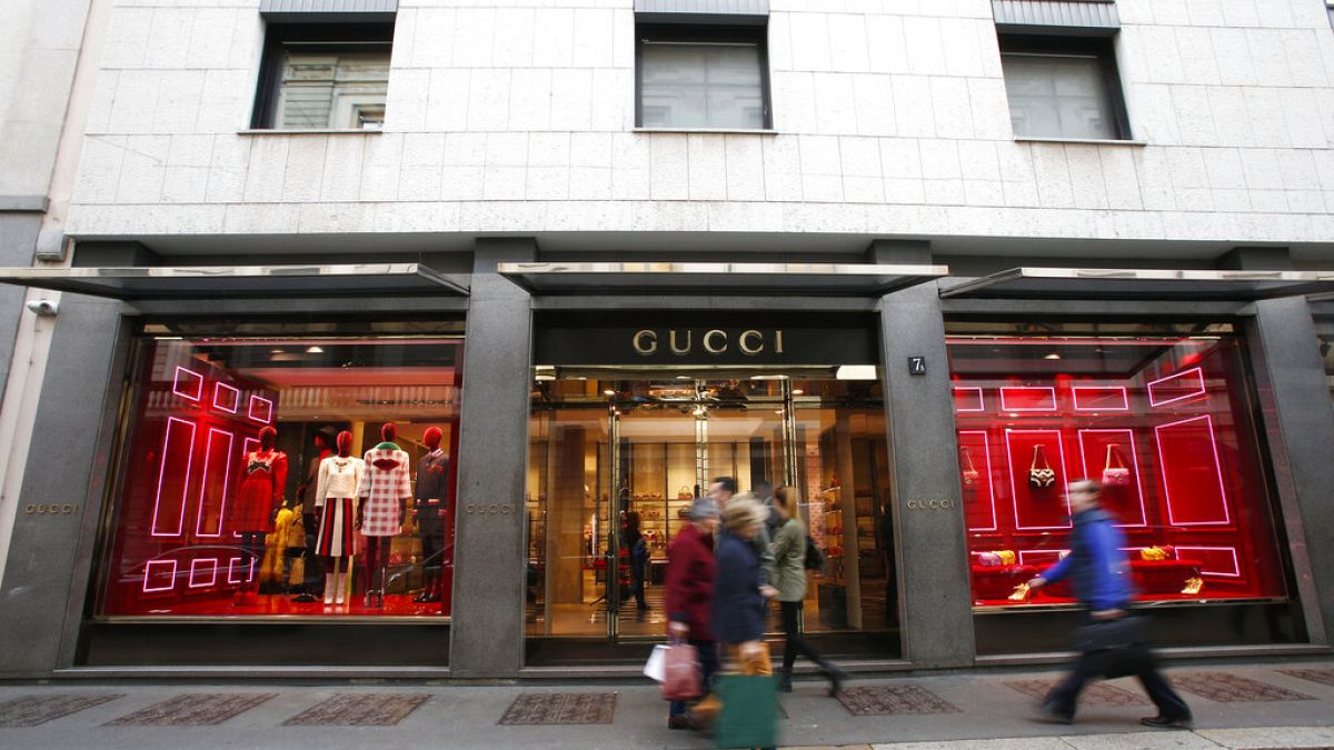 People walk in front of Gucci shop in Monte Napoleone street in Milan, Italy, Thursday, Oct. 20, 2016.