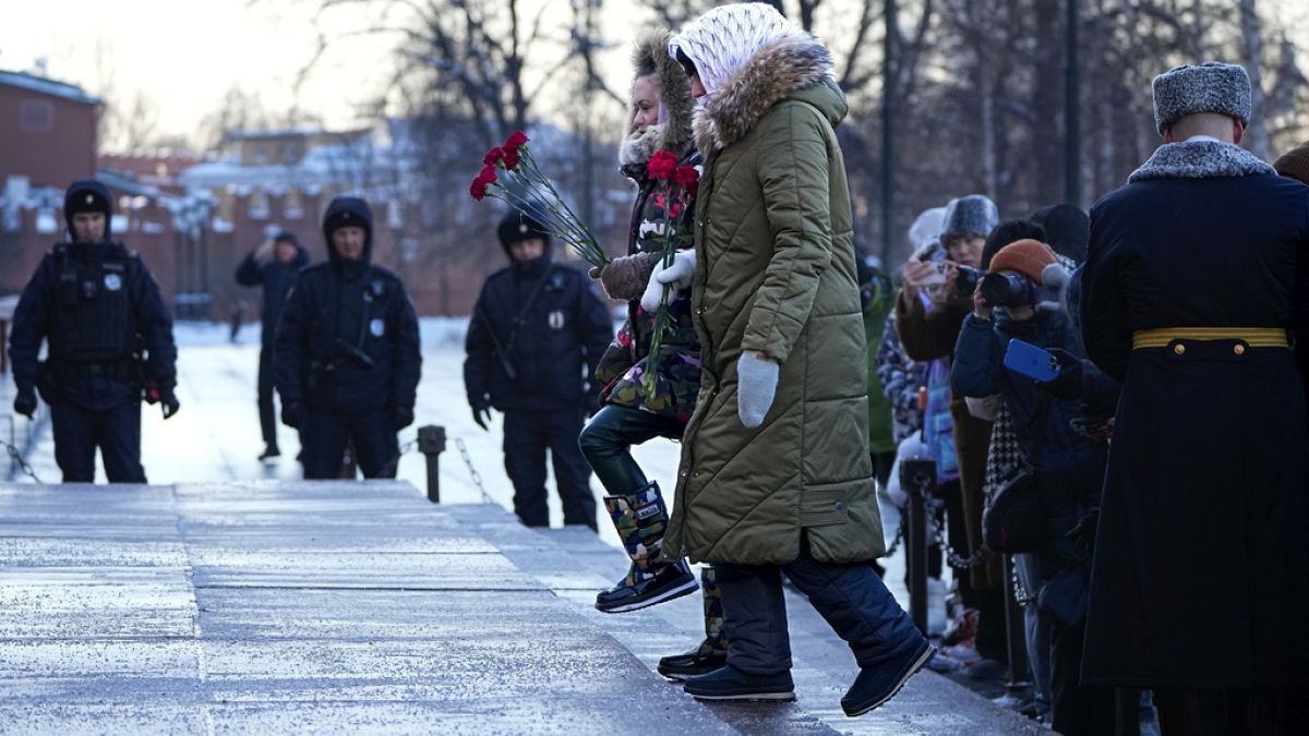 Wives of Russian soldiers mobilized for fighting in Ukraine walk to lay flowers at the Unknown Soldier