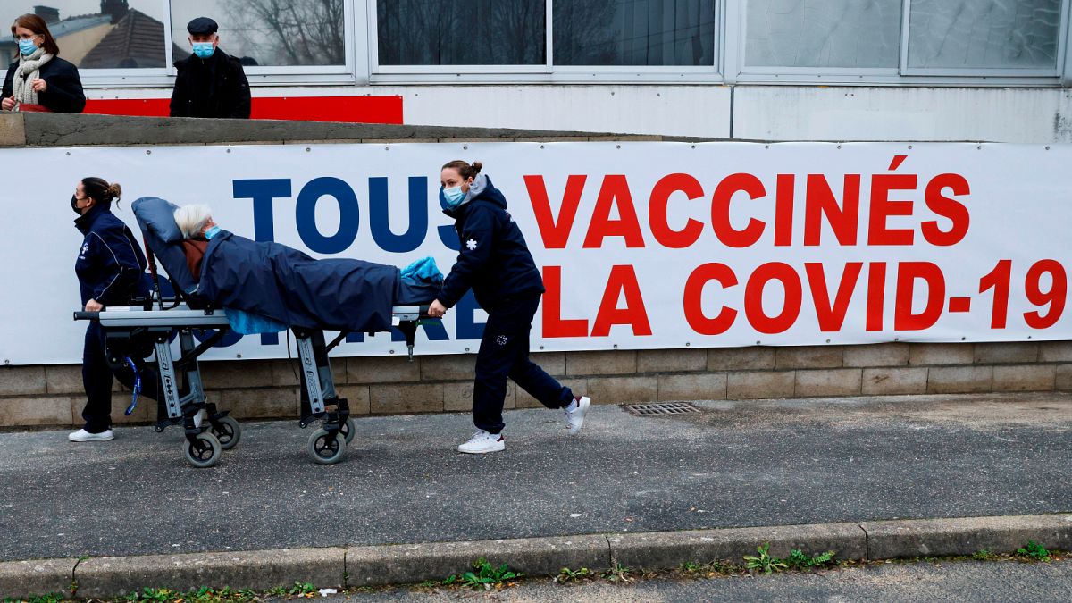 A woman is carried on a stretcher to the COVID-19 vaccination centre of the South Ile-de-France Hospital Group in Melun, in the outskirts of Paris, February 2021.