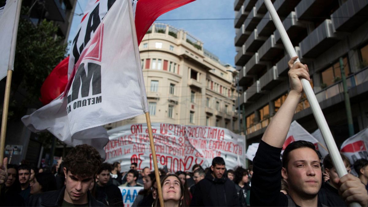 Protesters wave flags during a demonstration in central Athens, Greece, on Thursday, Jan. 18, 2024.