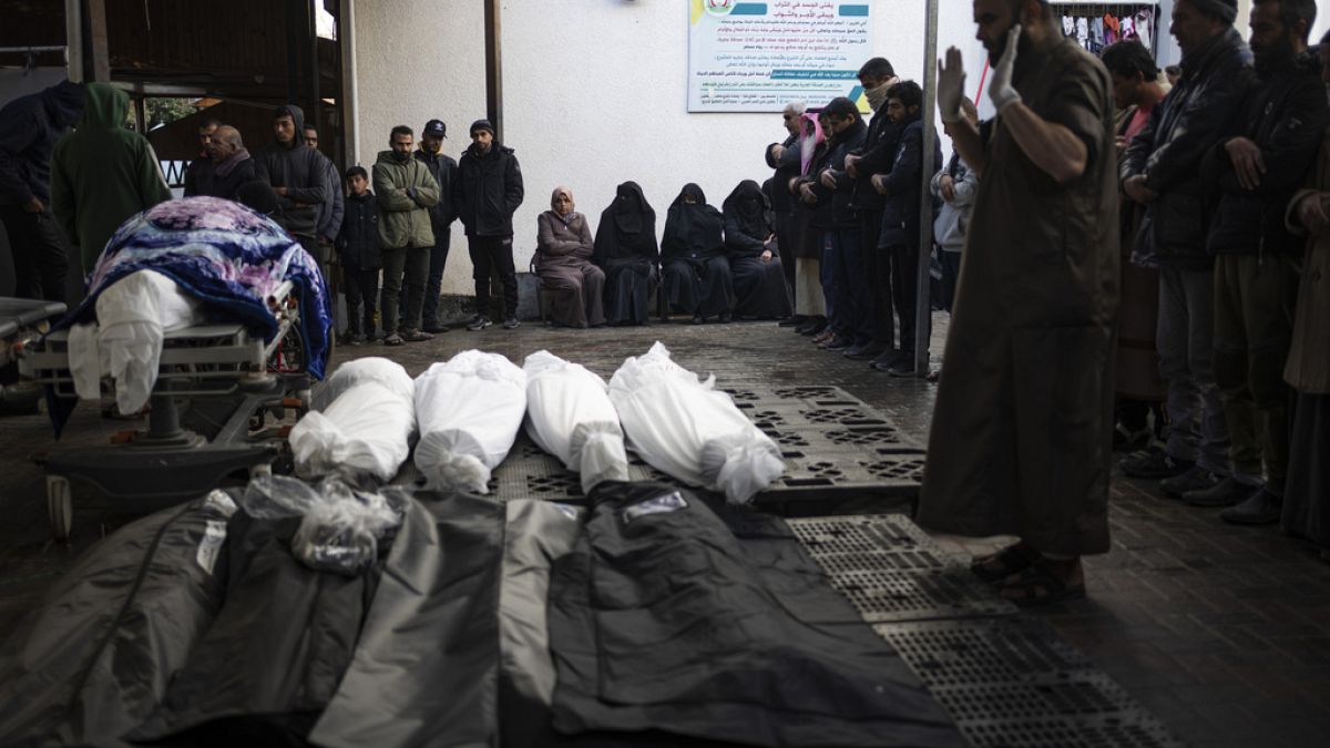 Palestinians pray next to the bodies of those who were killed in the Israeli ground offensive and bombardment of Khan Younis, outside a morgue in Rafah, southern Gaza.