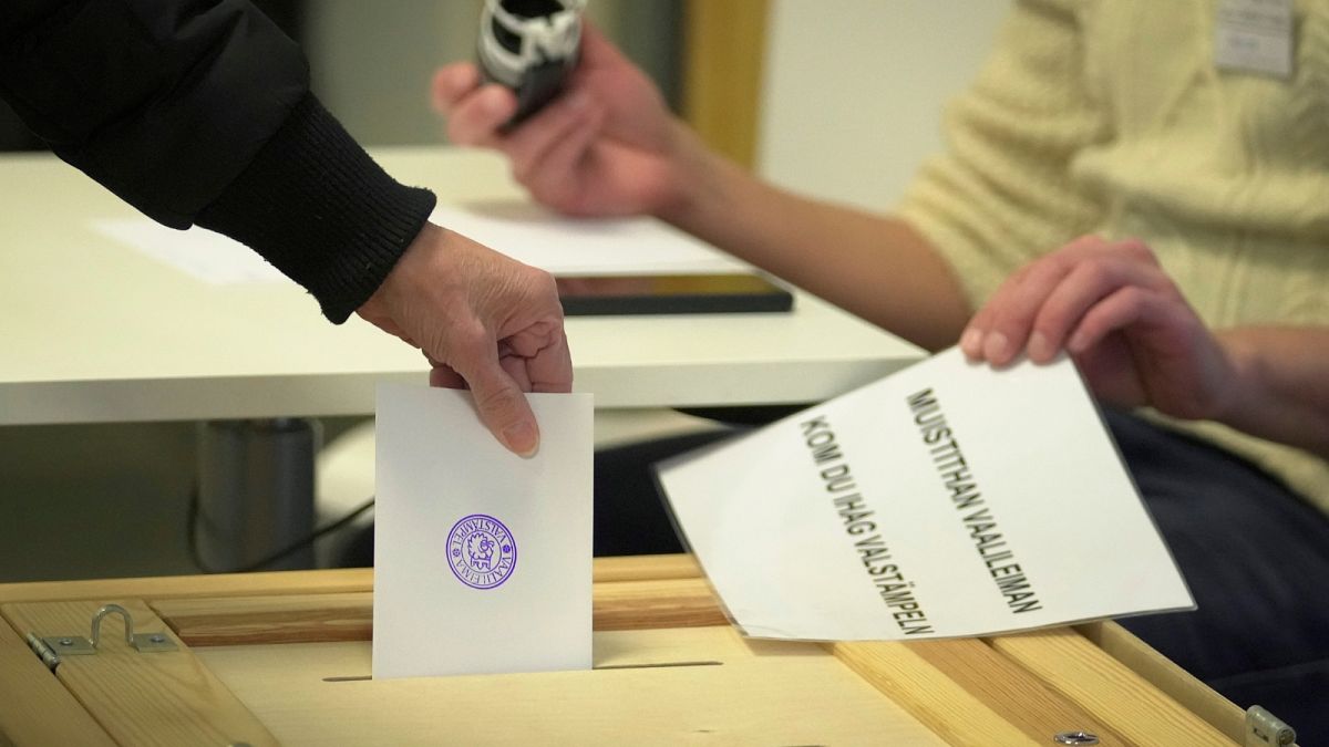 A woman casts her ballot at a polling station during presidential election in Helsinki, Finland, Sunday, Jan. 28, 2024.