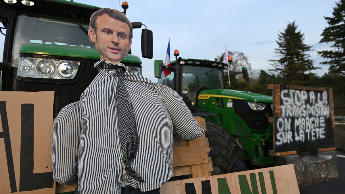 An effigy of French President Emmanuel Macron is seen on a tractor as farmers demonstrate on a highway,.
