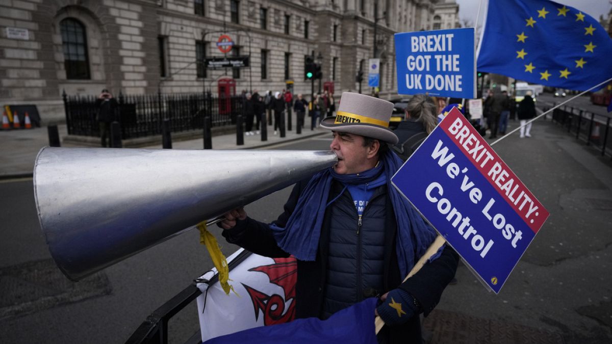 Anti-Brexit protester Steve Bray demonstrates on the edge of Parliament Square across the street from the Houses of Parliament, in London, Wednesday, Dec. 8, 2021.