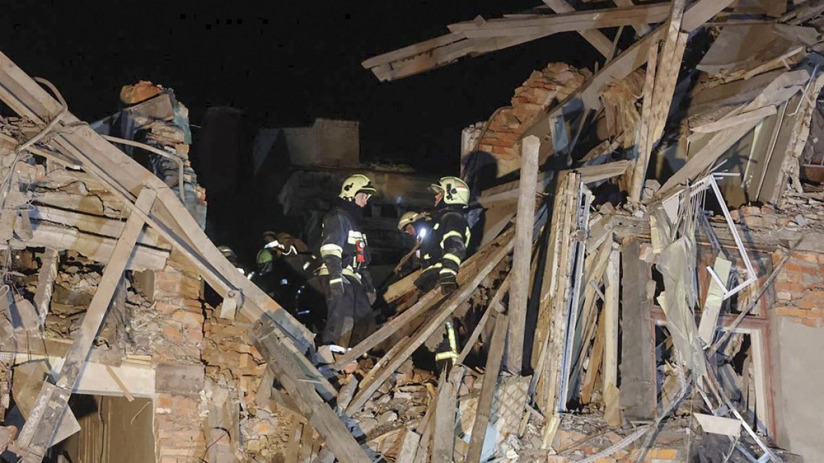In this photo provided by Kharkiv Regional Administration, emergency workers work in an apartment house damaged in Russian rocket attack is seen in Kharkiv, Ukraine, in the ea
