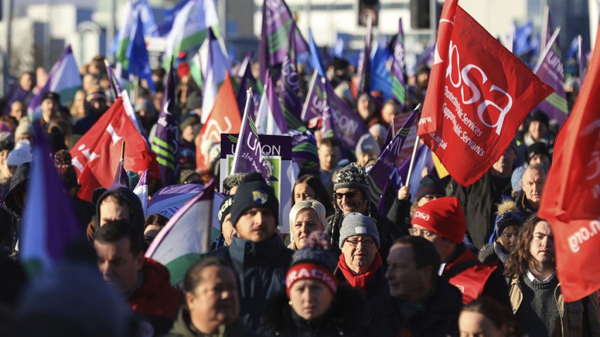 Public sector workers walk from the picket line at the Royal Victoria Hospital to a rally at Belfast City Hall, in Belfast, 18 January 2024.