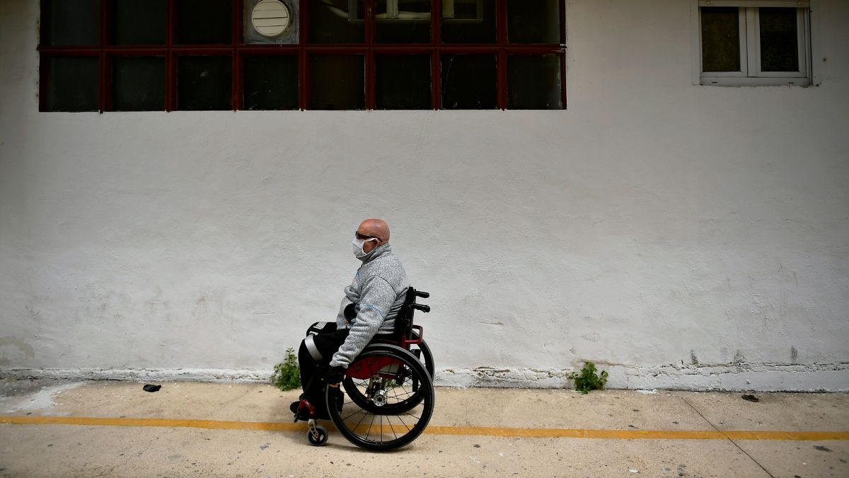 FILE: Man in a wheelchair in Estella, northern Spain, Wednesday, April 22, 2020.