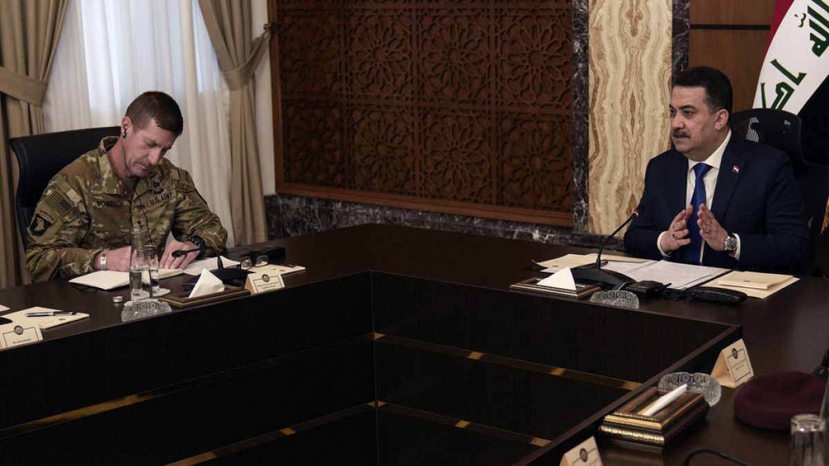 Iraqi Prime Minister Mohammed Shia al Sudani (R) and Major General Joel