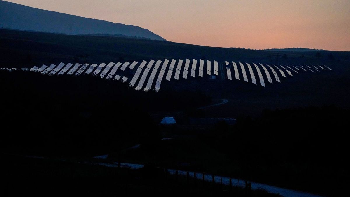 Solar panels are illuminated by the first light of dawn in Collarmele, near L