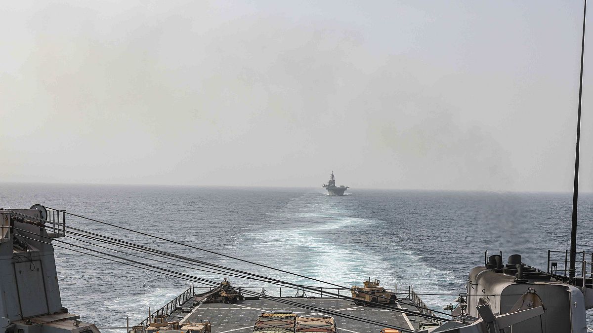 In this image provided by the U.S. Navy, the amphibious dock landing ship USS Carter Hall and amphibious assault ship USS Bataan transit the Bab al-Mandeb strait