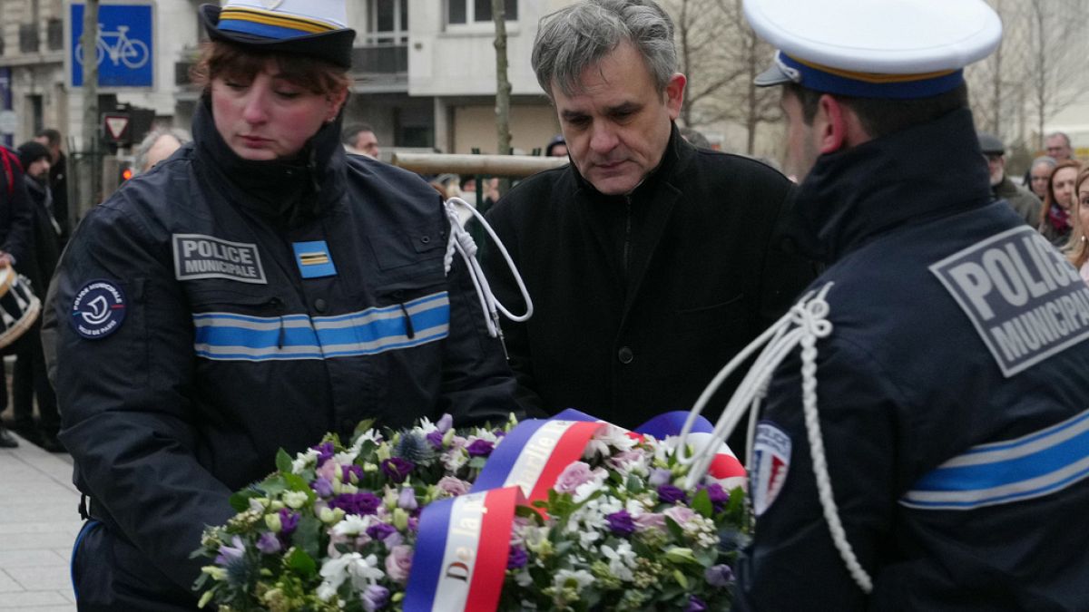 Charlie Hebdo publication director Laurent Sourisseau lays a wreath in tribute to police officer Ahmed Merabet, a victim of the jihadist attack, on 7 January, 2024.