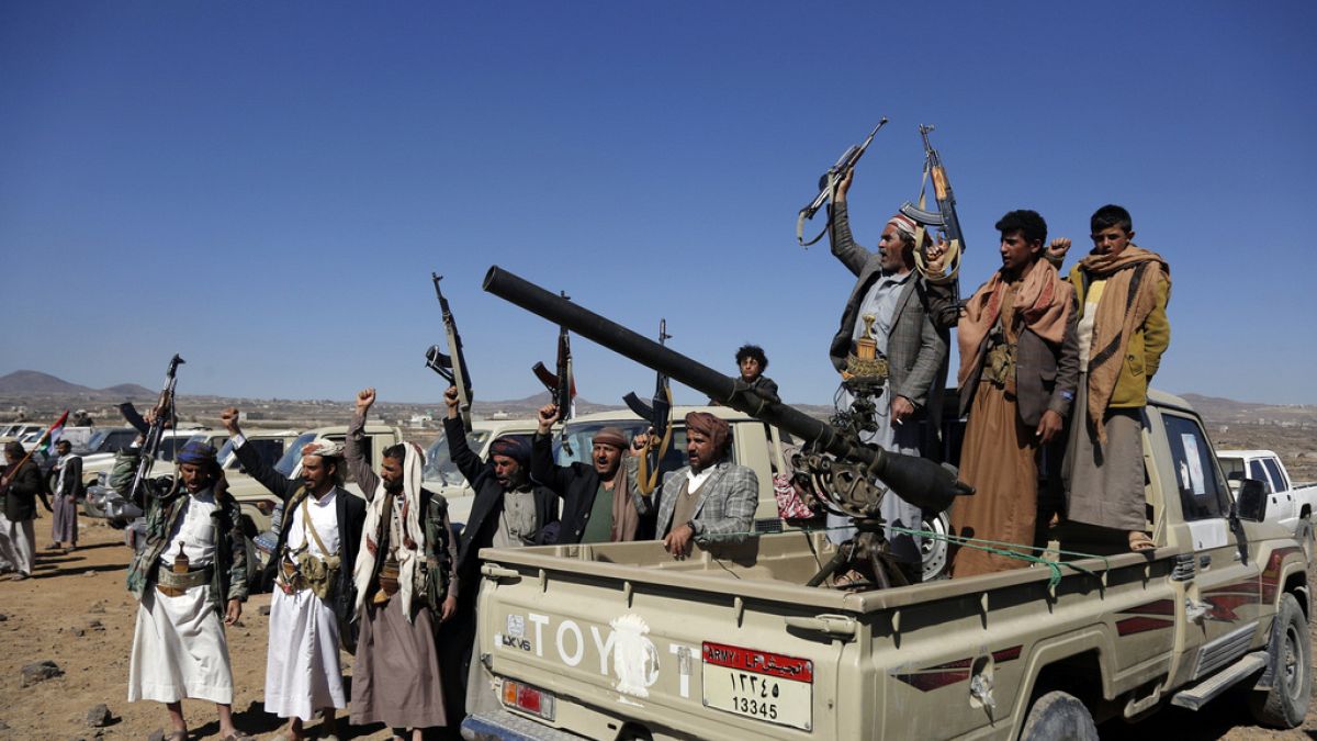 Houthi fighters and tribesmen stage a rally against the U.S. and the U.K. strikes on Houthi-run military sites near Sanaa, Yemen, on Sunday, Jan. 14, 2024.