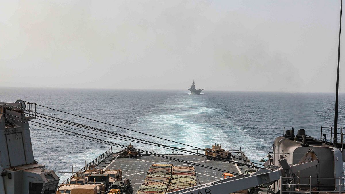 In this image provided by the U.S. Navy, the amphibious dock landing ship USS Carter Hall and amphibious assault ship USS Bataan transit the Bab al-Mandeb strait,