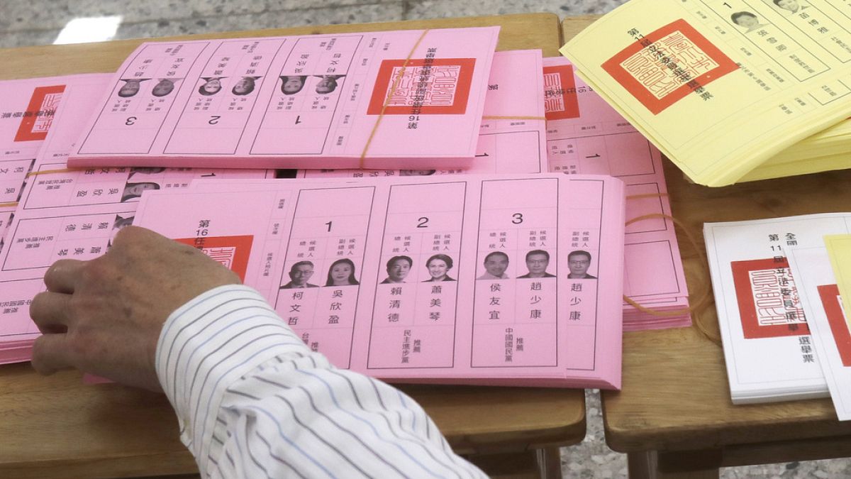 A staff sorts ballot papers at a polling station in Taipei, Taiwan on Saturday