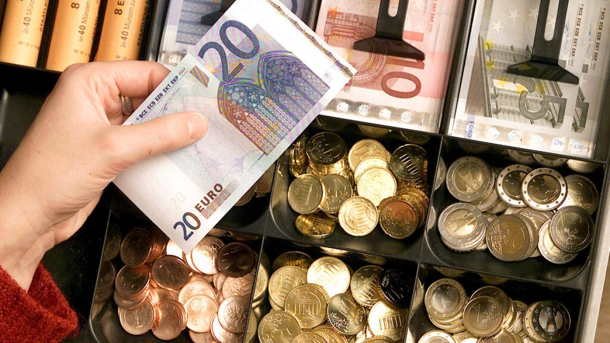 Euro coins and banknotes are pictured in a shop in Duisburg, Germany.