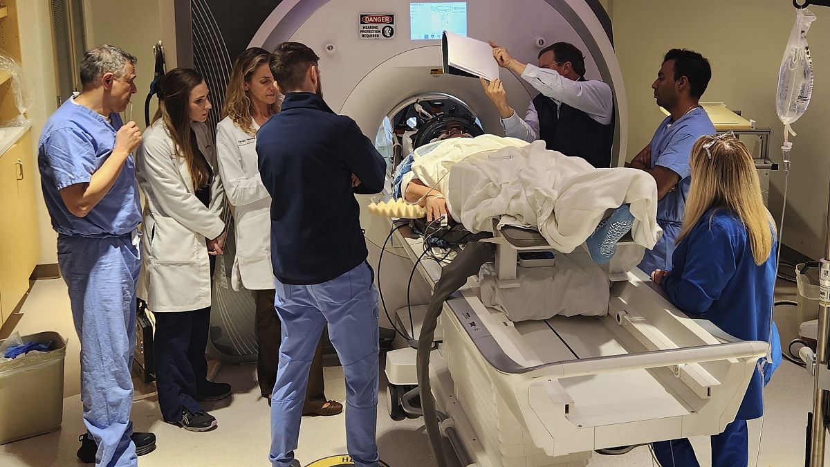 In this photo provided by the WVU Rockefeller Neuroscience Institute, an Alzheimer’s patient undergoes focused ultrasound treatment with the WVU RNI team in West Virginia.