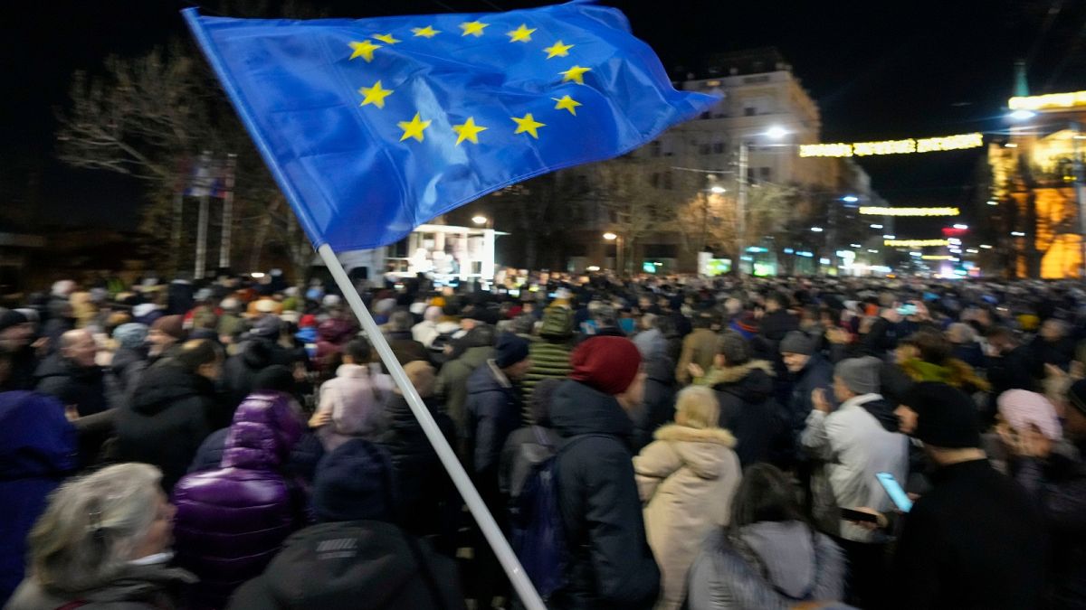 A protester waves an EU flag during a rally in downtown Belgrade, Serbia, Tuesday, Jan. 16, 2024.