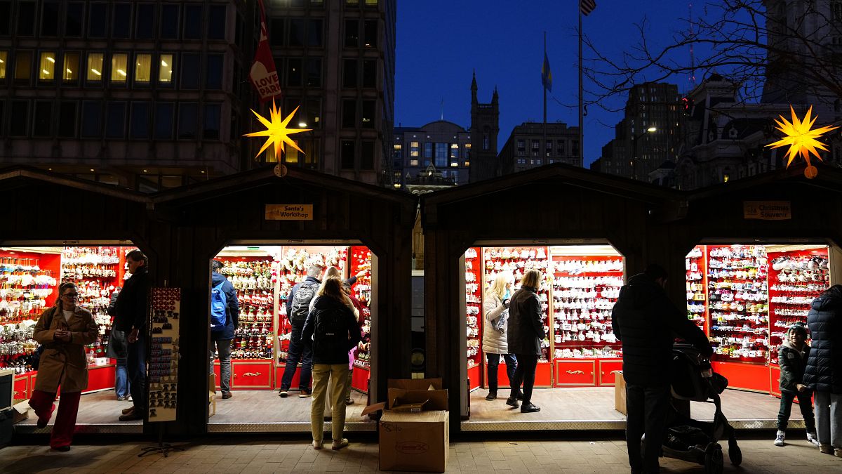 Shoppers visit the Christmas Village in Philadelphia, Dec. 13, 2023.
