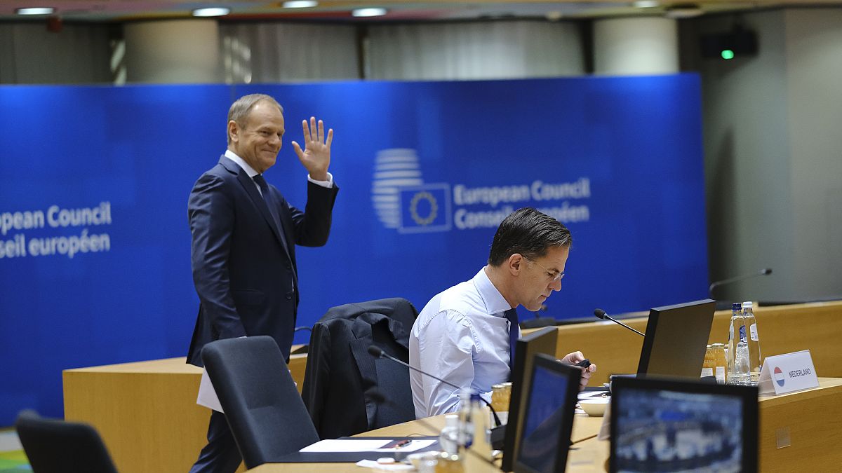 Polish prime minister Donald Tusk behind Dutch counterpart Mark Rutte on 15 December at a European Council summit just days after returning to power.