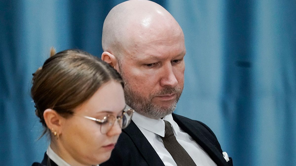 Anders Behring Breivik and attorney Marte Lindholm sits, as the Oslo district court conducts his case in a gymnasium at Ringerike prison, in Ringerike, Norway, Monday, Jan. 8,