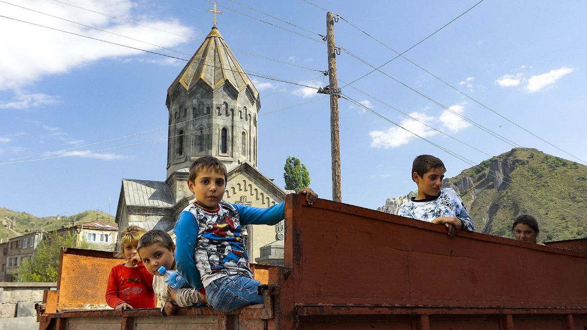 Ethnic Armenian children from Nagorno-Karabakh look from a truck after arriving in Armenia