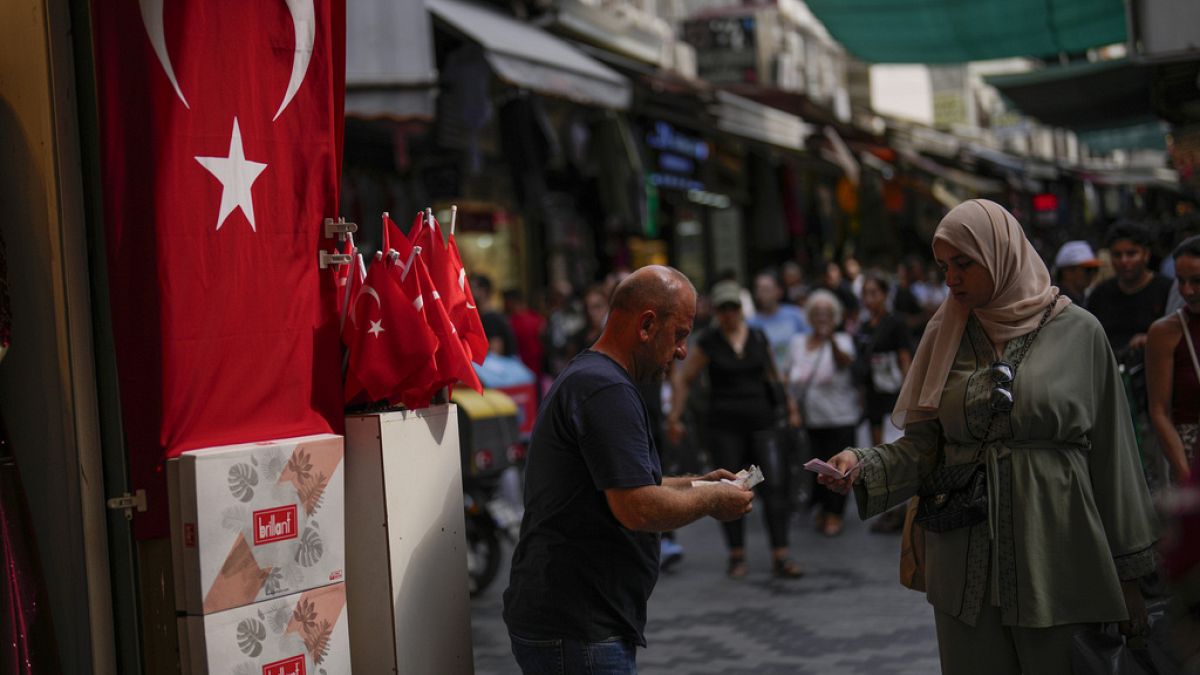 A seller talks to a customer in a street market in Istanbul, Turkey, on Sept. 6, 2023.