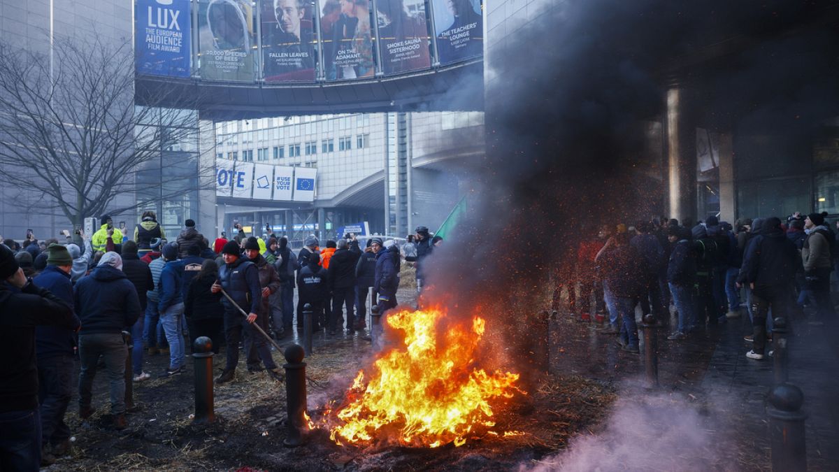 Farmers burn straw and tyres during a protest outside the European Parliament as European leaders meet for an EU summit in Brussels, Thursday, Feb. 1,