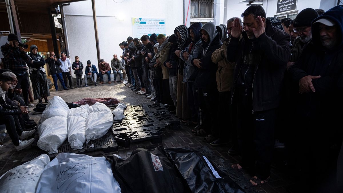 Palestinians mourn their relatives, killed in the Israeli bombardment of the Gaza Strip, outside a morgue in Rafah.