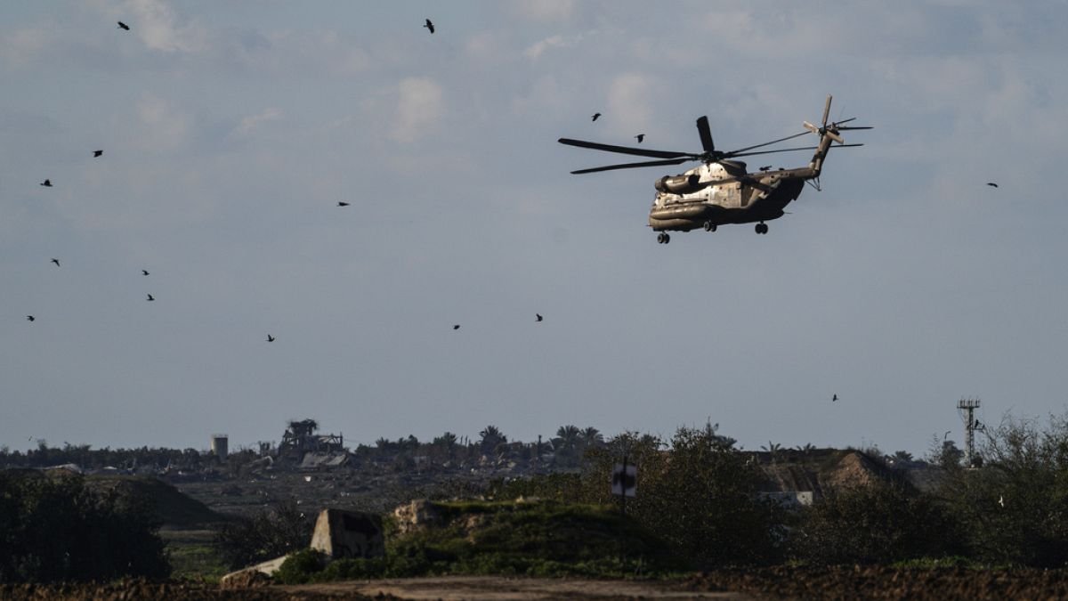 An Israeli military helicopter, seen from southern Israel, flies into the Gaza Strip, Friday, Feb. 9, 2024.