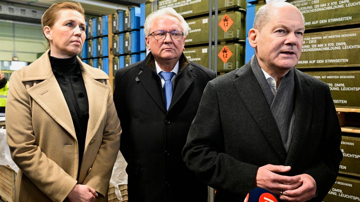 German Chancellor Olaf Scholz, right, accompanied by Danish Prime Minister Mette Frederiksen, left, and CEO of Rheinmetall Armin Papperger.