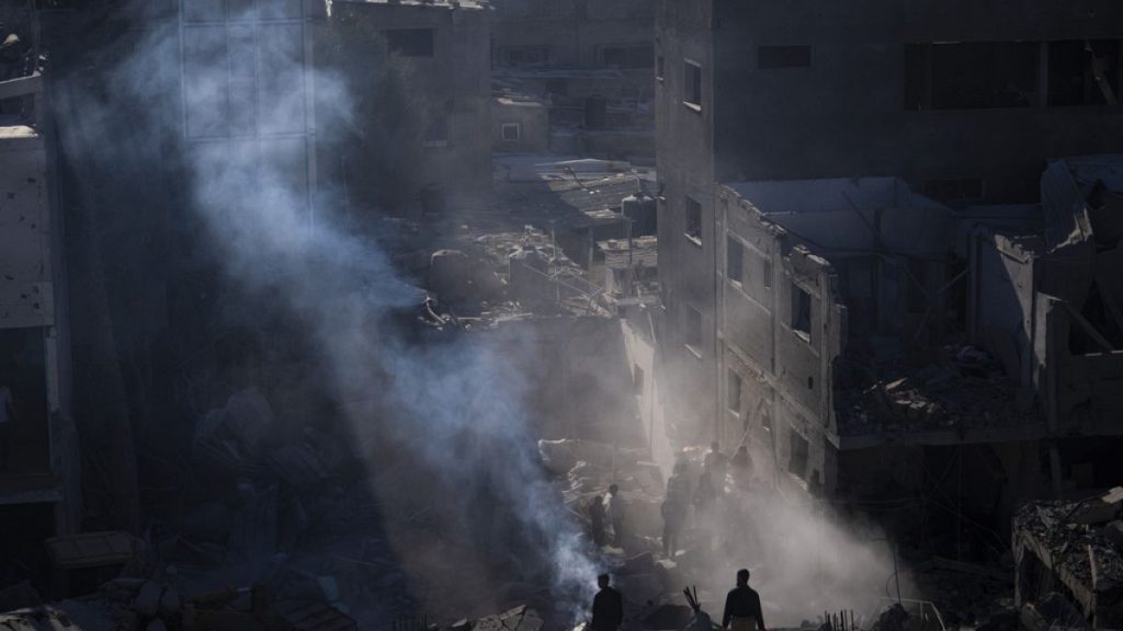 Palestinians look at the destruction after an Israeli strike on residential buildings and a mosque in Rafah, Gaza Strip, Thursday, Feb. 22, 2024.