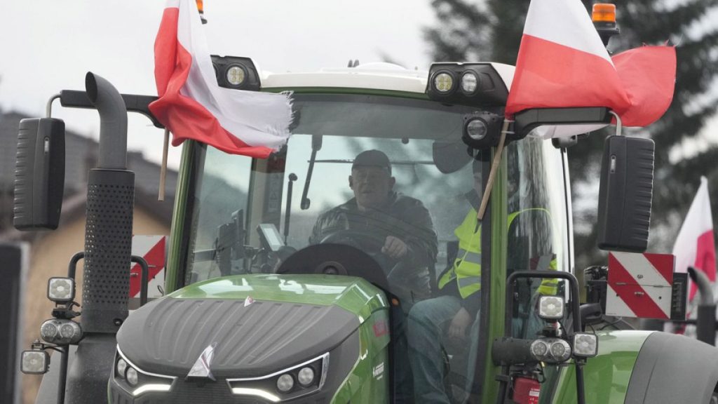 Polish farmers drive tractors in a convoy in Minsk Mazowiecki, Poland, on Tuesday Feb. 20, 2024.