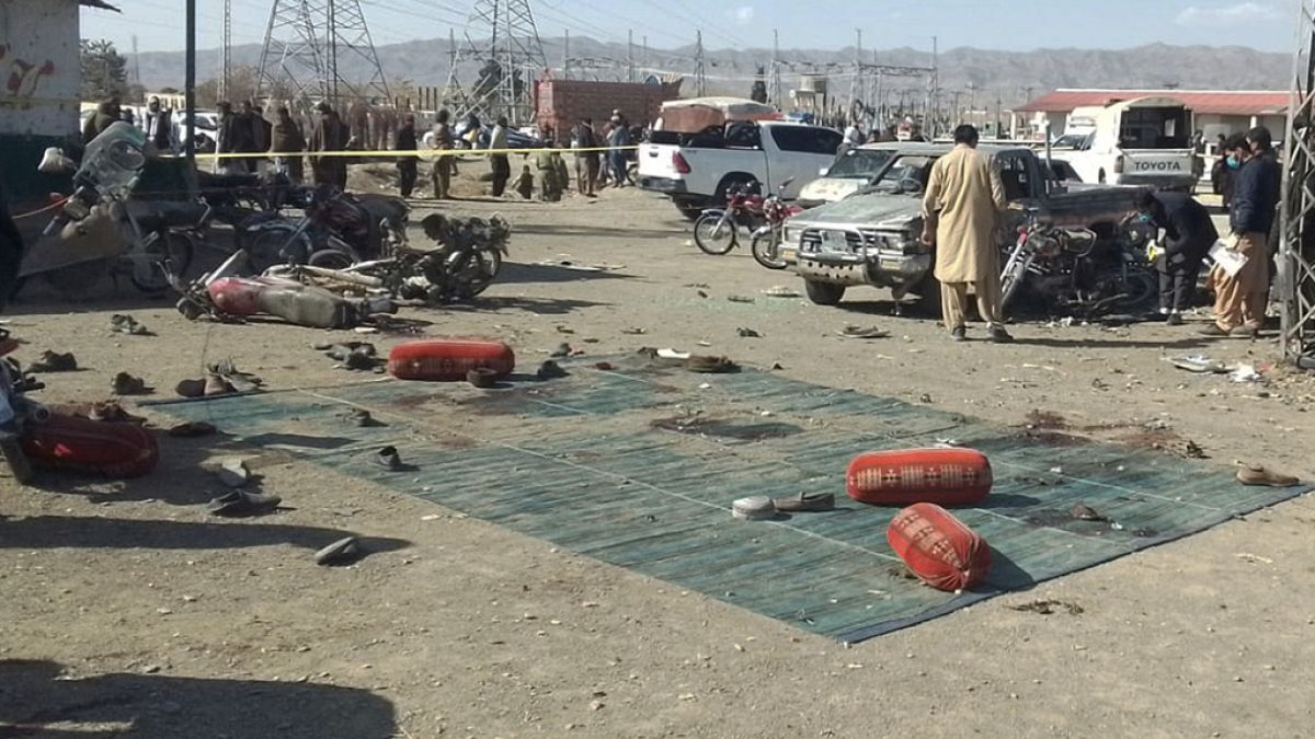 Security officials examine the scene of a bomb blast in Khanozai, Pashin, a district of Pakistan