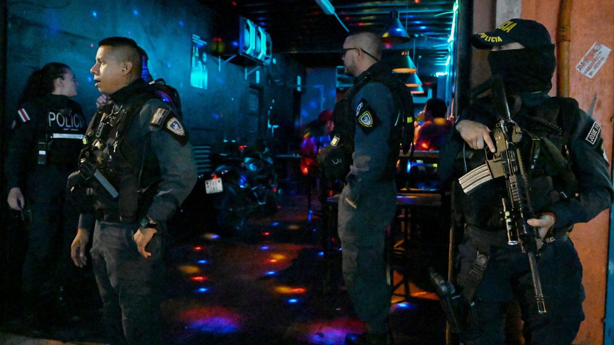 Police officers run a checkpoint set up in a nightclub zone of San Jose, Costa Rica, Saturday, Aug. 18, 2023.