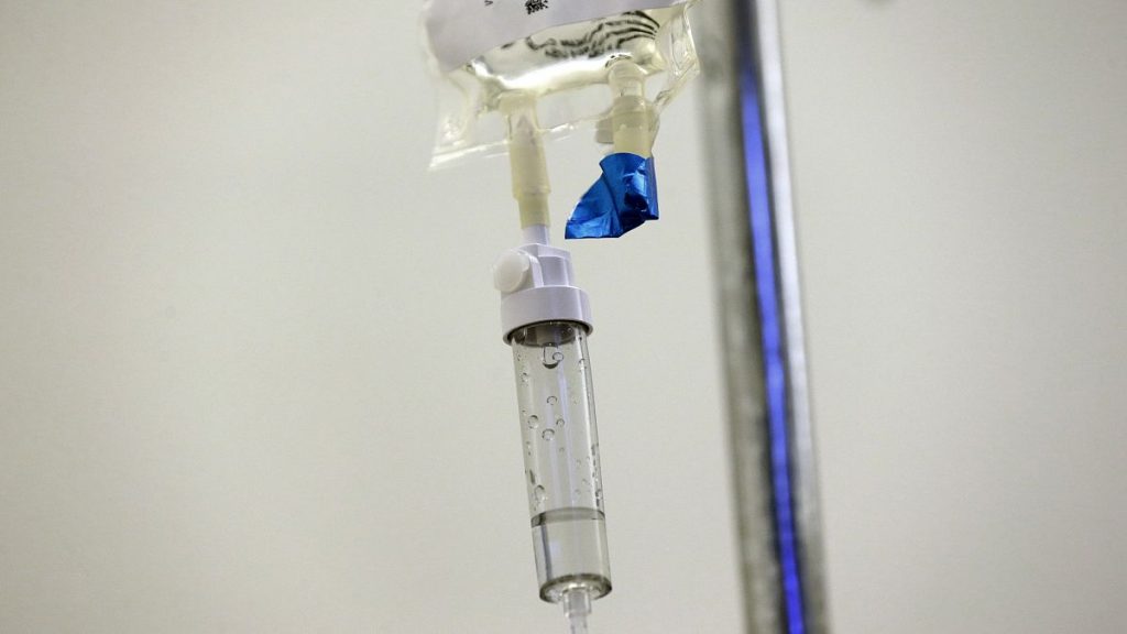 Chemotherapy drugs are administered to a patient at a hospital.