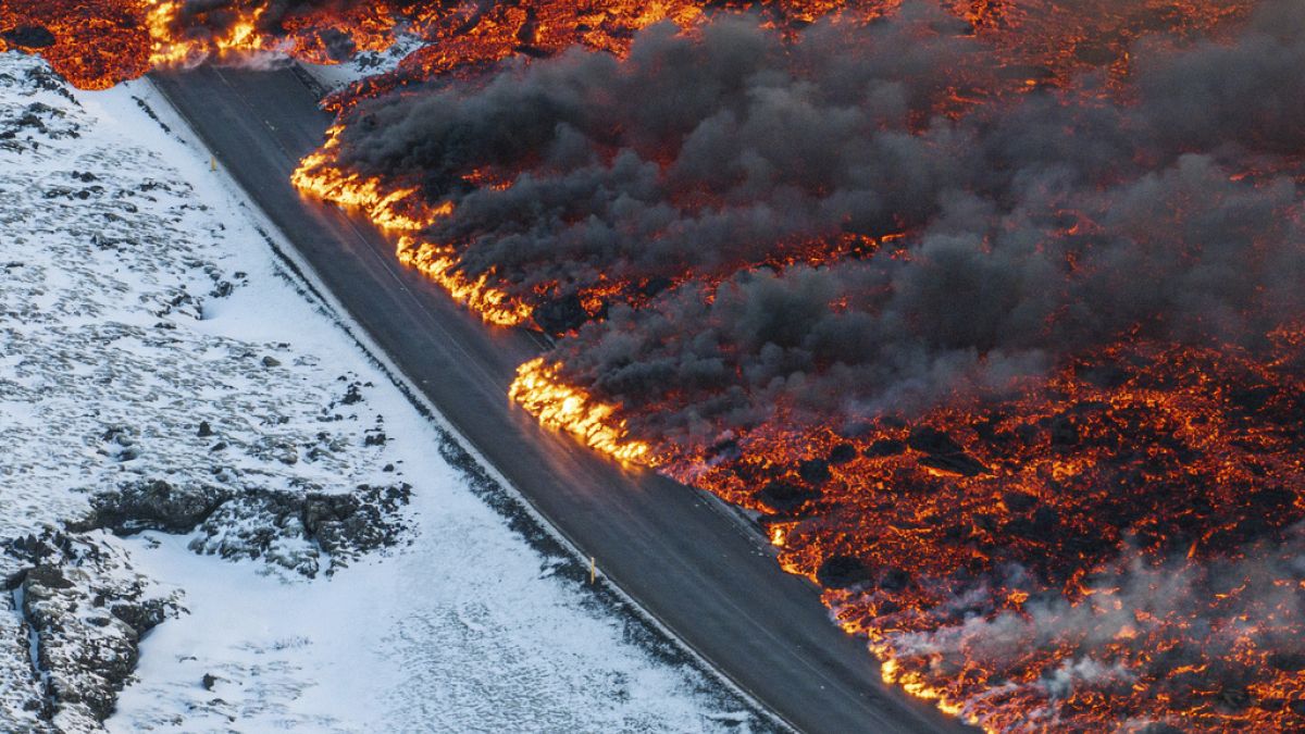 A view of lava crossing the main road to Grindavík and flowing on the road leading to the Blue Lagoon, in Grindavík, Iceland, Thursday, 8 Feb. 2024.