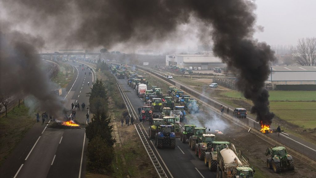 Farmers make barricades after blocking a highway during a protest near Mollerussa, northeast Spain, Tuesday, Feb. 6, 2024.
