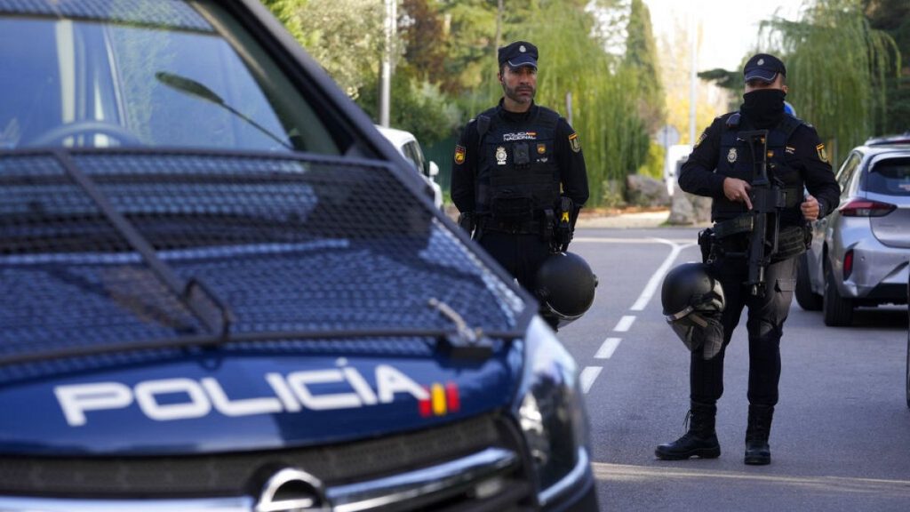 Police officers stand guard as they cordon off the area next to the Ukrainian embassy in Madrid, Spain, Nov. 30, 2022