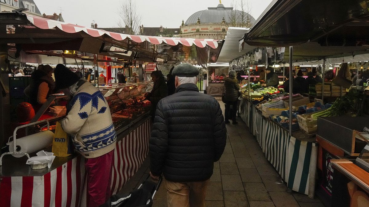 People shop at an open air market in Fontainebleau, south of Paris, France, Friday, Feb. 2, 2024.