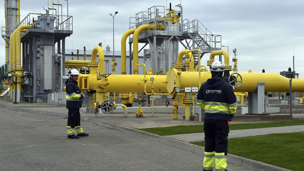 Workers stand near the pipelines during an opening ceremony of the Baltic Pipe in Budno, Poland, Tuesday, Sept. 27, 2022.