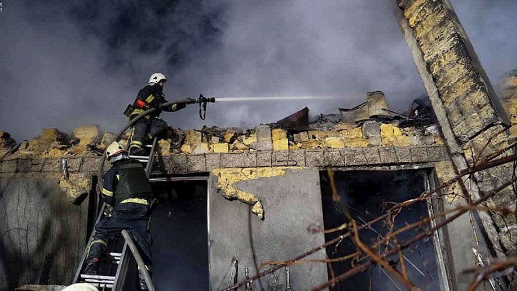 Firefighters work on the site of a burning building after a Russian attack in Odesa, Ukraine, Feb. 23, 2024.
