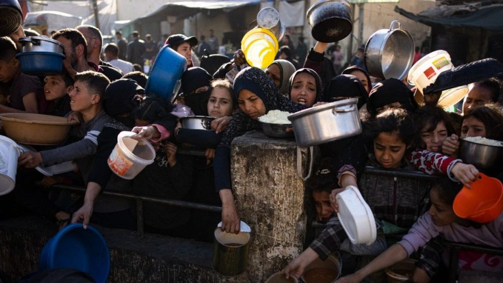 Palestinians line up for a free meal in Rafah, Gaza Strip, on Tuesday, March 12, 2024.