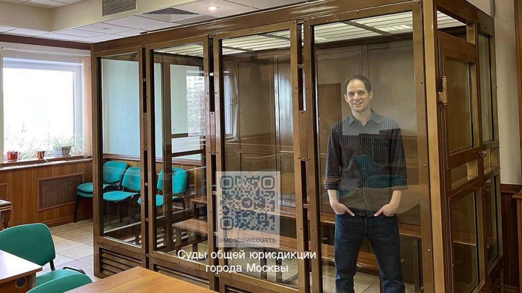 Wall Street Journal reporter Evan Gershkovich stands in a glass cage in a courtroom at the Moscow City Court in Moscow, Russia, Tuesday, March 26, 2024.